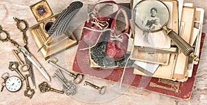 Antique books and photos, keys, baby shoes and writing accessories