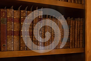 antique bookstore, shelf with old books and editions, library background