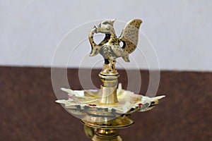 Antique brass candlestick in the form of a bird