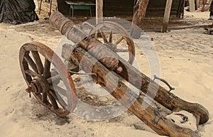 Antique brass cannon with wooden carriage and wheels