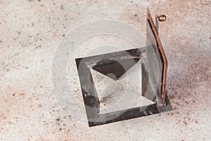 Antique brass chimney flap on gray oncrete background