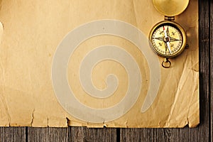 Antique brass compass over old background