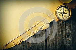 Antique brass compass over old background