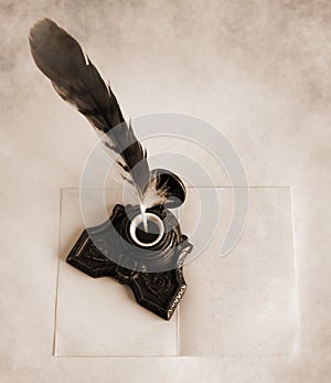 Antique brass inkwell with feather