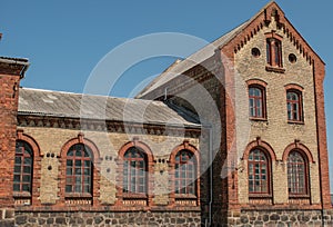 Antique brick two-tone house with large windows