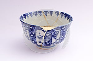 Antique broken Japanese tea bowl repaired with gold kintsugi technique