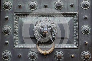 Antique bronze door knocking knob ring in the form of a lion`s face