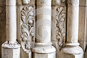 Antique building`s detail of white limestone pillars or columns
