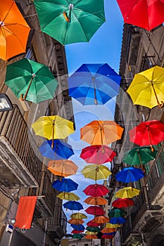 Antique bystreet decorated with colored umbrellas.