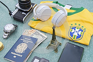 Antique camera, silver wristwatch, Brazilian soccer team t-shirt, headphones