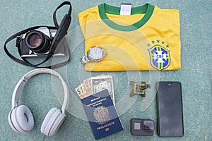 Antique camera, silver wristwatch, Brazilian soccer team t-shirt, headphones