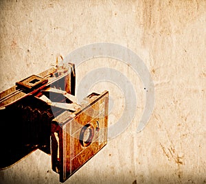 Antique camera on vintage paper background
