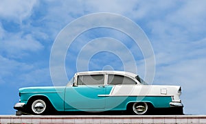 Antique car against a blue sky