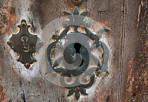 Antique carved keyhole in a retro woden door,