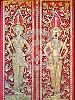 Antique carving golden Thai pattern or Lai Thai on red background.