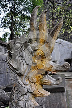 Antique carving in stone with mythical motif. Bich pagoda,