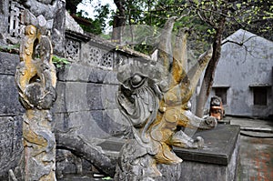 Antique carving in stone with mythical motif. Bich pagoda,