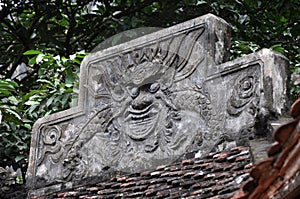 Antique carving in stone with mythical motif. Bich pagoda,