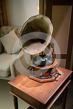 Antique classic retro gramophone on wooden table. Music box. Vintage interior concept.