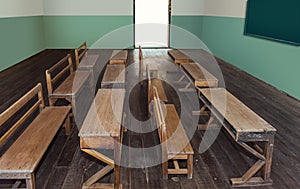 Antique classroom in school with Rows of empty wooden desks