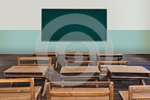 Antique classroom in school with Rows of empty wooden desks