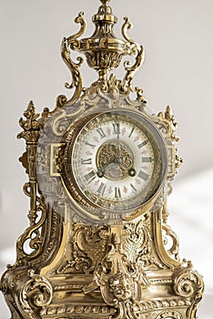 Antique clock photo close up, old bronze clock in gilding, front of bronze fireplace clock, e