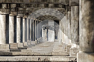 Antique colonnade. Stone pillars and stairs. Ancient colonnade