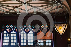 Antique Colorful Glass Chandelier in Bookshop and Large Windows