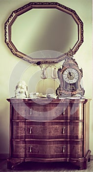 Antique commode with a mantel clock