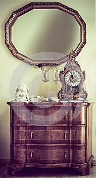 Antique commode with a mantel clock photo