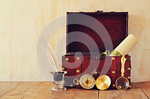 Antique compass, inlwell and old wooden chest on wooden table