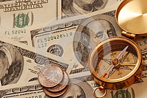 Antique compass over money