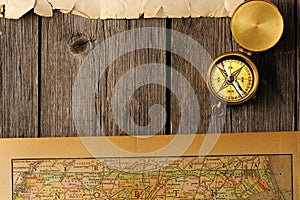 Antique compass over old map