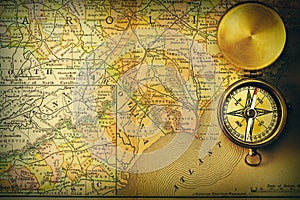 Antique compass over old XIX century map photo