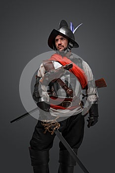 Antique conquistador with sword isolated on grey background