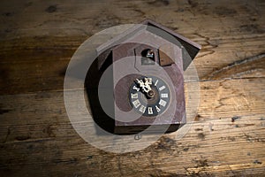 antique cuckoo wall clock on wood background ,time concept