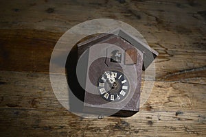 antique cuckoo  wall clock on wood background ,time concept image,time concept image