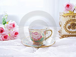 Antique cup of tea with pink rose on white background ,English tea vintage tone Valentine\'s day romantic