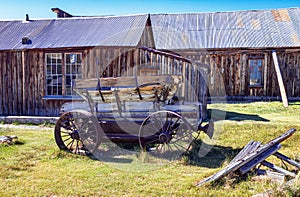 Antique discarded and abandoned Horse Drawn Wagon and Wood Building.