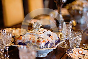 Antique dishes on a laid table at Scotney castle