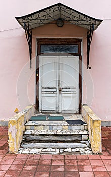 Antique door on the background of broken steps