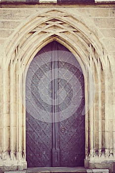 Antique door in lineal gothic arch with vintage treatment photo