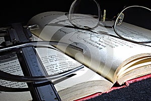 Antique Engineering book with Calipers in subdued light