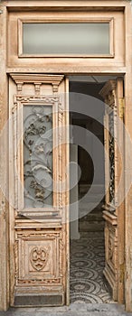 Antique entrance door with glass wrought-iron windows in Renaissance style