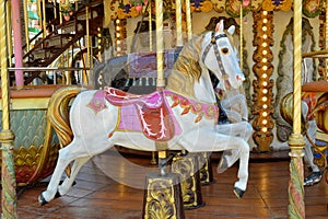 Antique fairground carousel with prominent horse