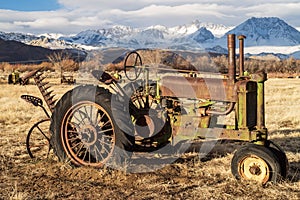 Antique farm tractor in mountain valley landscape