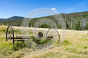 Antique farming hay rake in open field