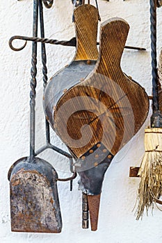 Antique fireplace bellows, broom and pal. Utensils for lighting and cleaning the fireplace