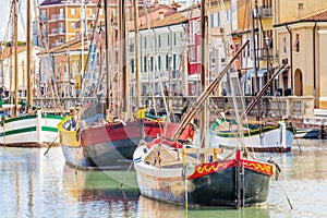 Antique fishing boats in harbor channel