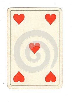 An antique five of hearts playing card.